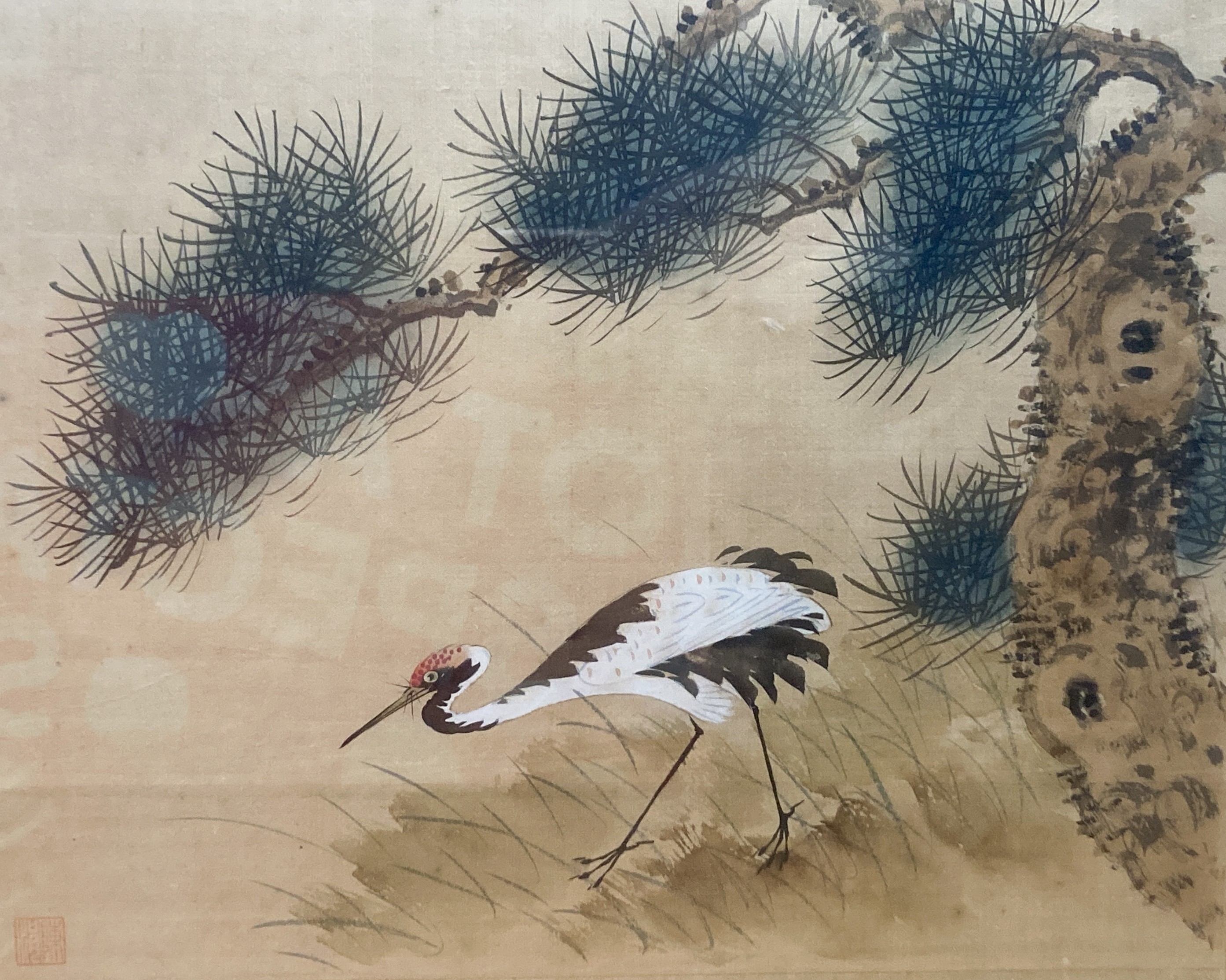 A Chinese watercolour on silk depicting a crane beneath a pin tree, 26 x 36cm with silk border, glazed frame